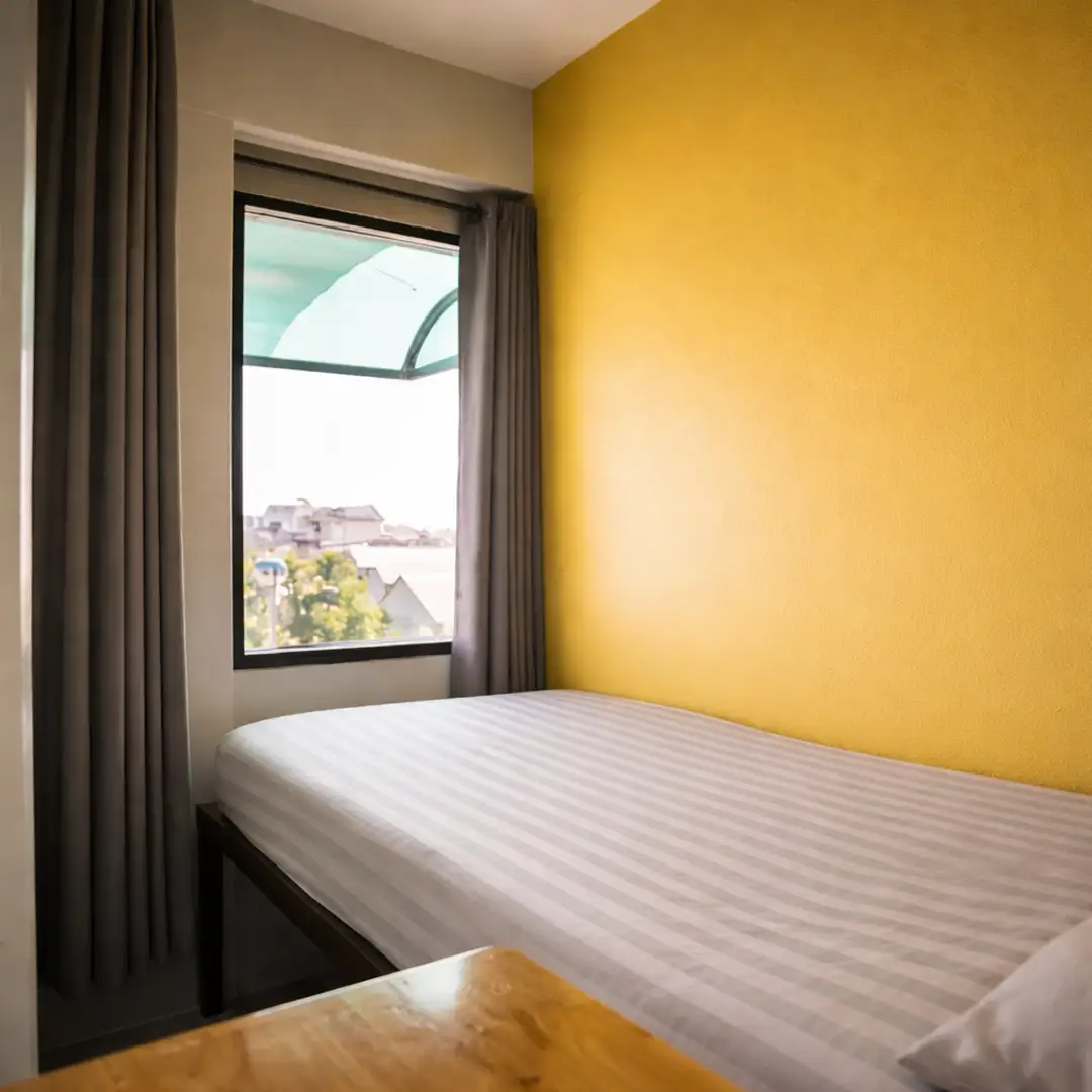 Single bed in a semi-private pod dorm with air conditioning at a Chiang Mai hostel